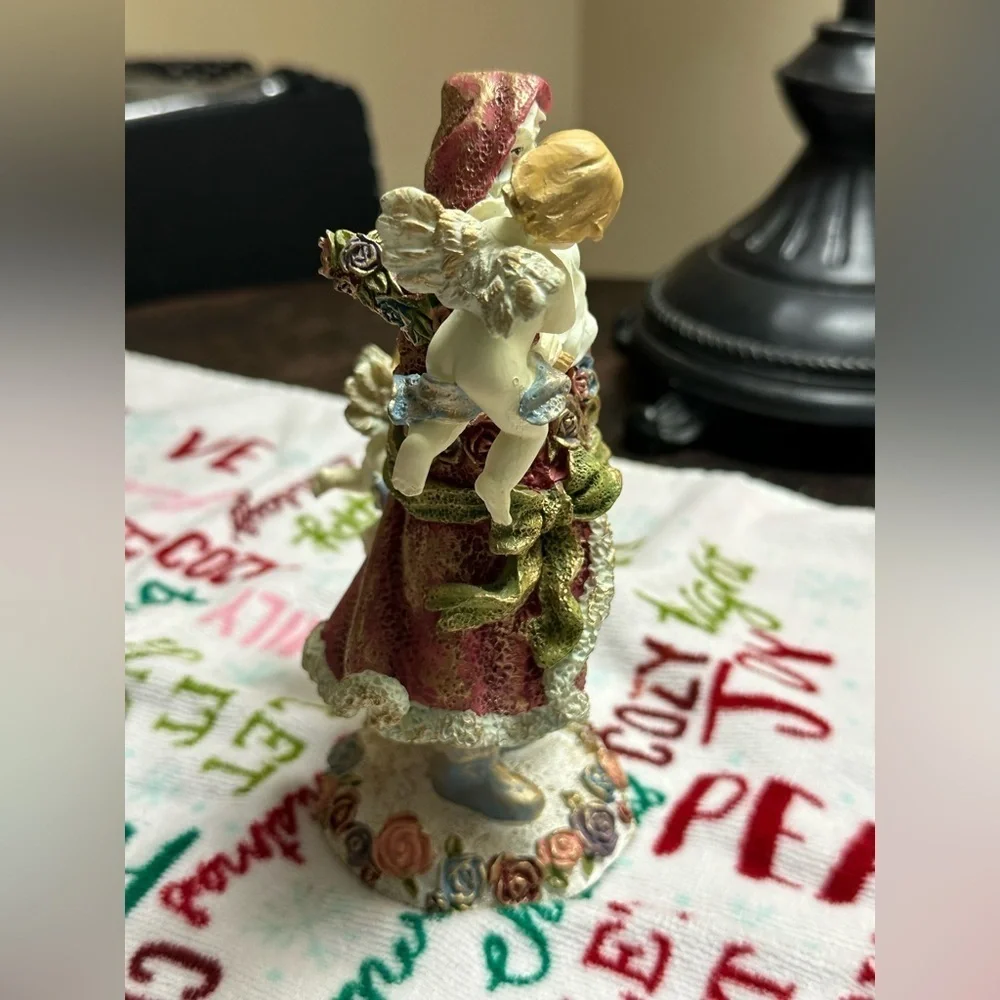 Festive Santa Figurine with Cherubs